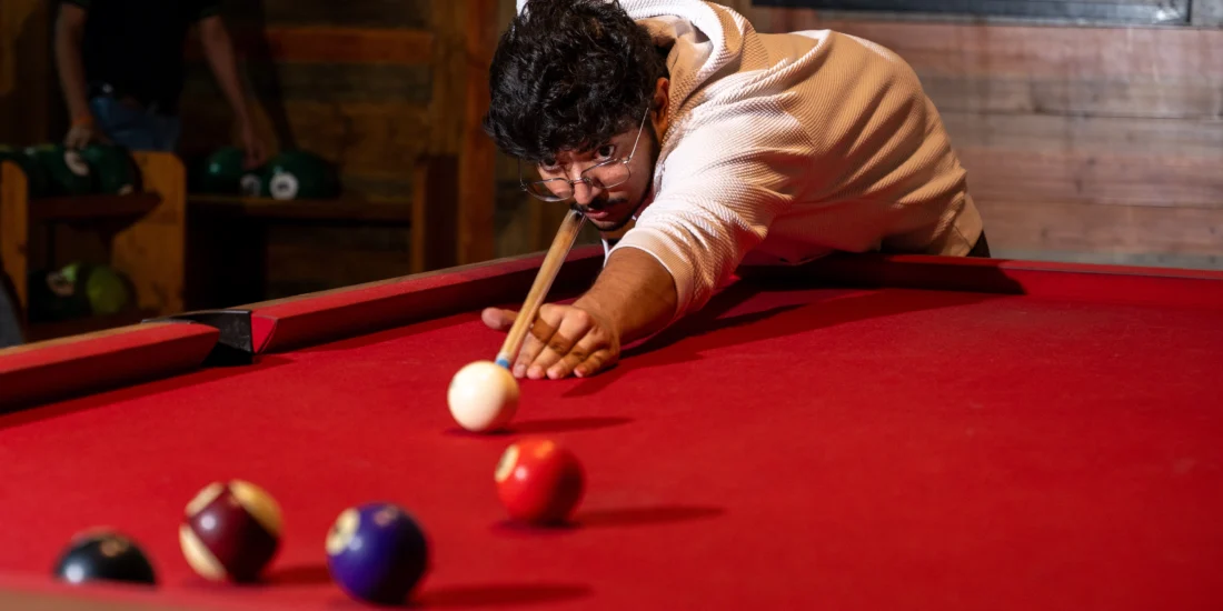 Man with white shirt aiming the ball in 8pool