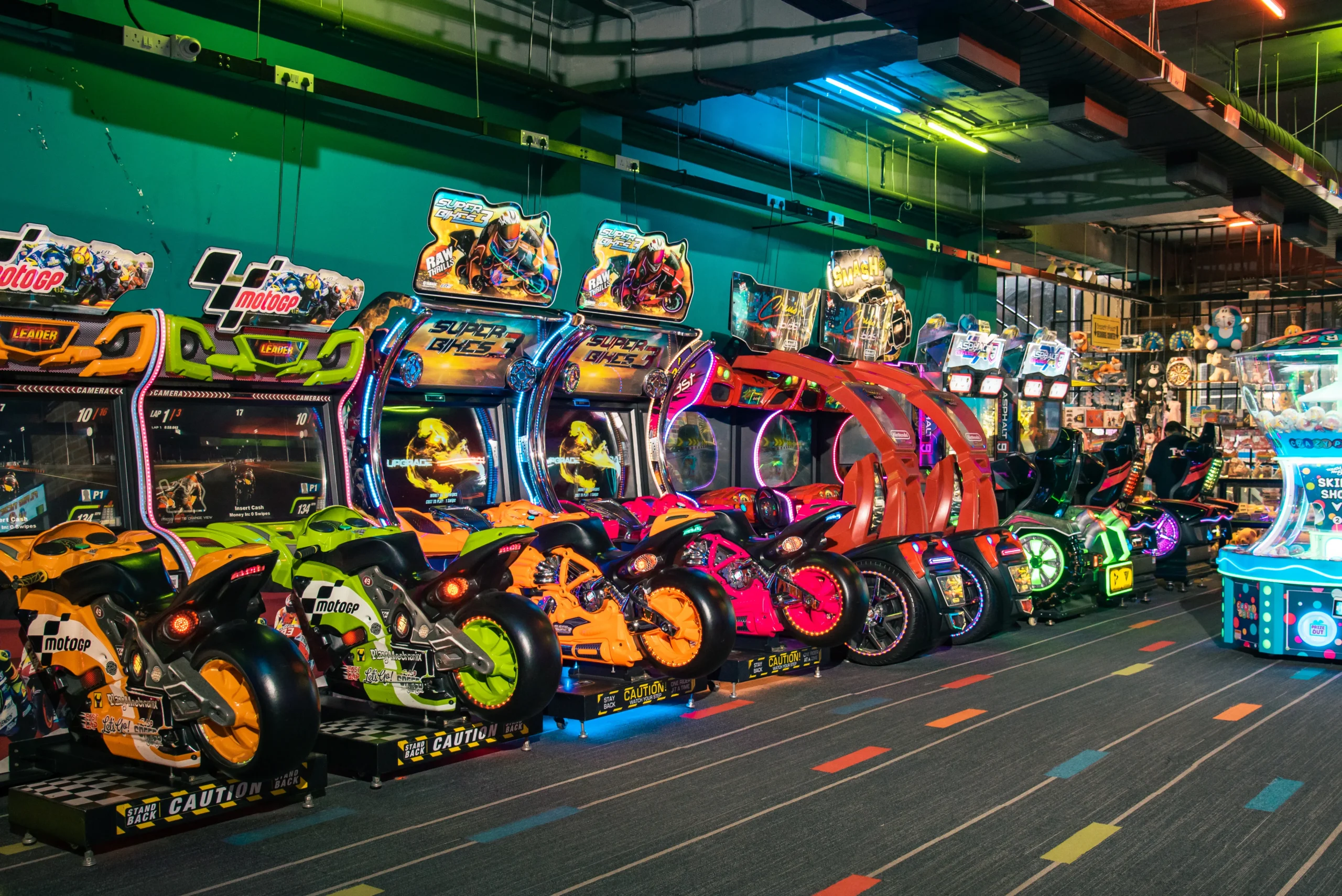 A row of colorful arcade machines lined up in a spacious indoor gaming area, inviting players to enjoy various games