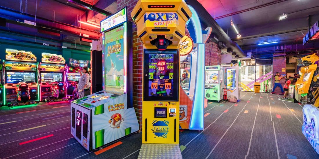 An energetic game room featuring a variety of arcade machines and games, perfect for entertainment and social interaction