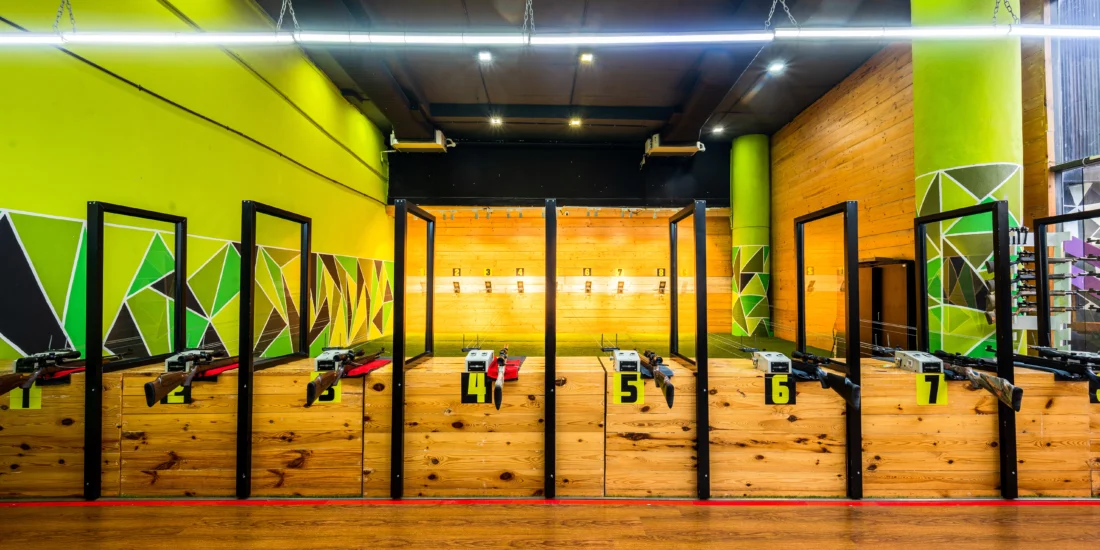 A large indoor shooting range showcasing wooden and green walls, providing a controlled environment for shooting practice