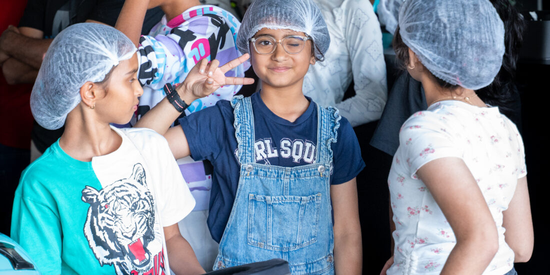 small little girl with hair cap ready to ride Go Karting