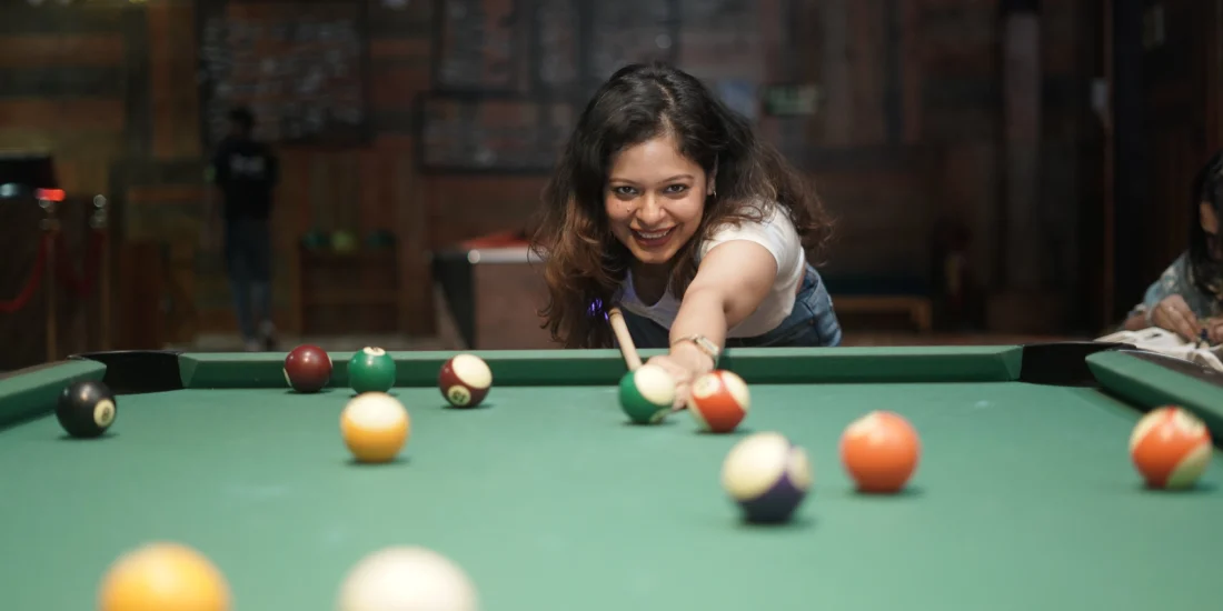 Girl giving a pose and playing 8pool