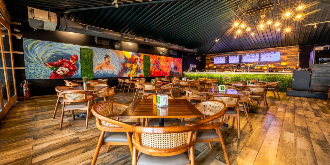 A large mural decorates the wall of the restaurant, adding vibrant color and artistic flair to the dining atmosphere