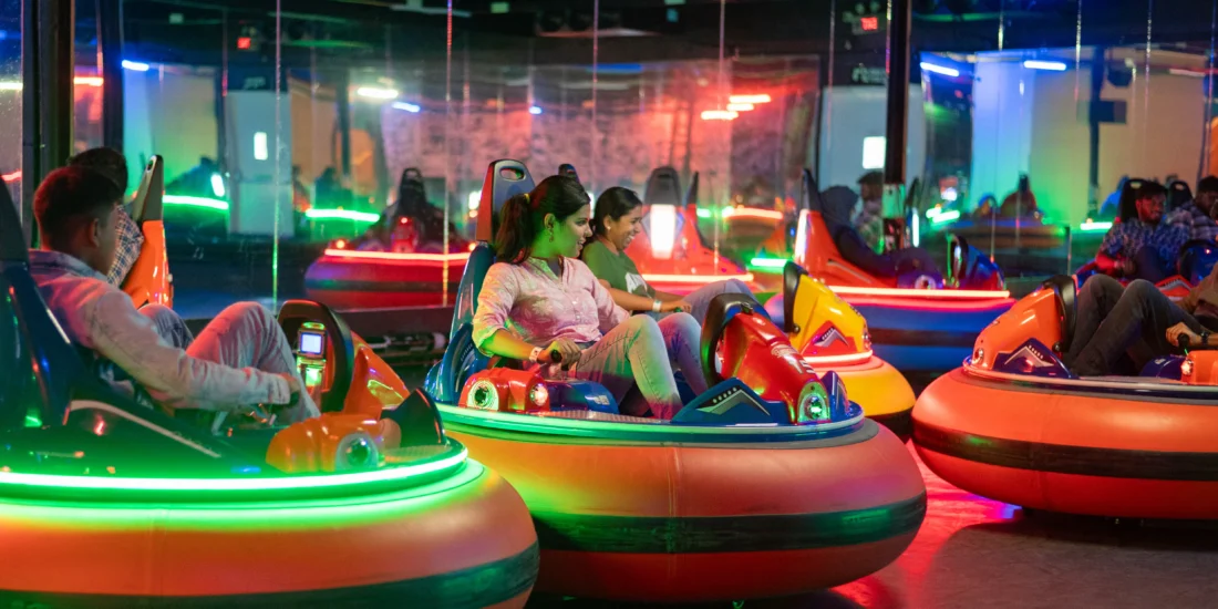 A lively group of people enjoying bumper cars at an amusement park, laughing and having fun in colorful vehicles