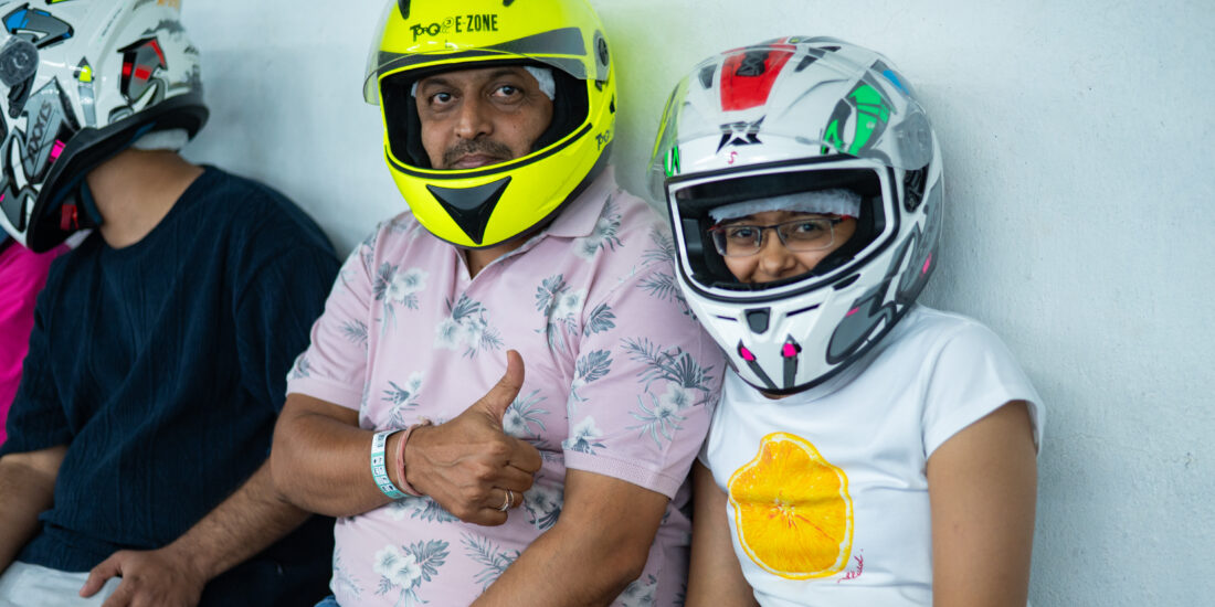 Son and father sitting with helment to ride Go Karting