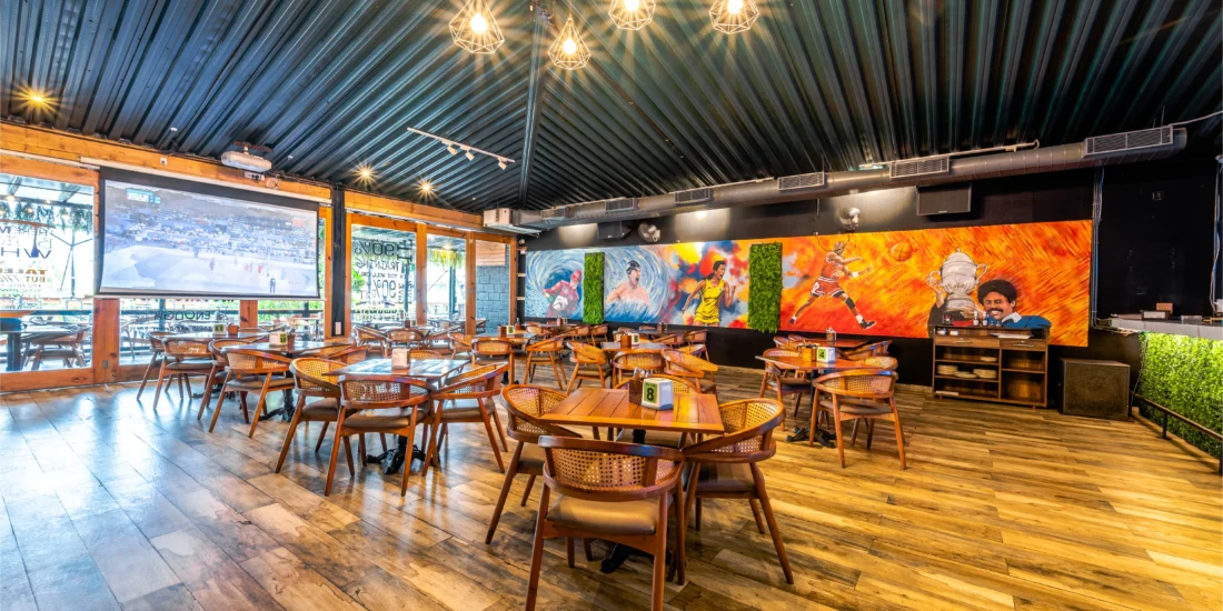 A large mural decorates the wall of the restaurant, adding vibrant color and artistic flair to the dining atmosphere