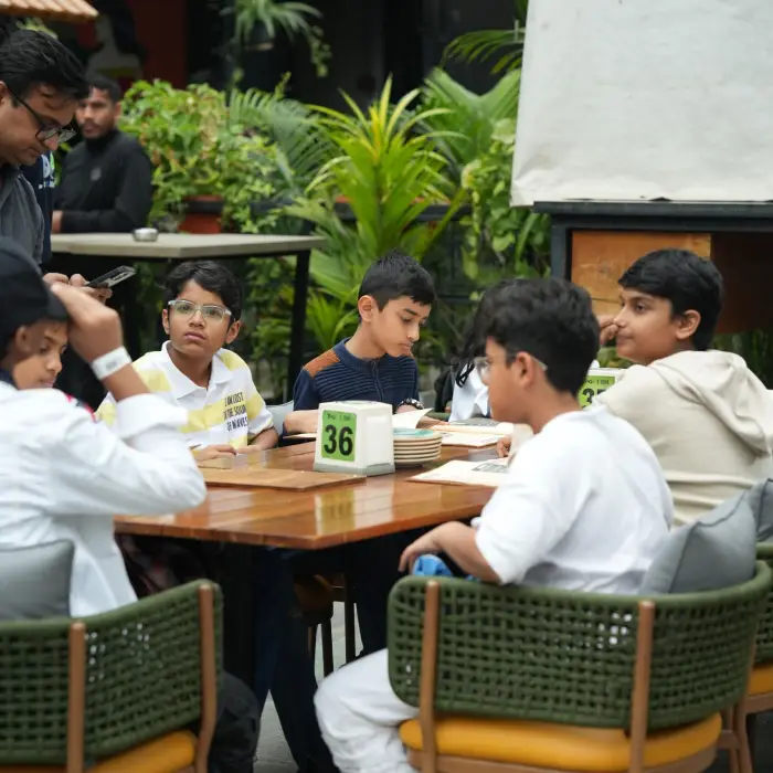 image shown of people sitting for - Celebrating Birthdays in Bangalore? Make It More Than Just Dinner