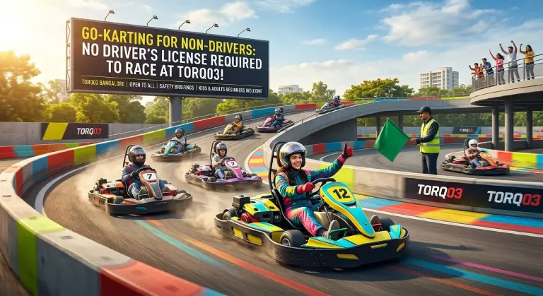 A beginner non-driver racing a cyan go-kart on the multi-level outdoor track at Torq03 Bangalore, passing a track marshal and a prominent billboard confirming no driver's license is required.